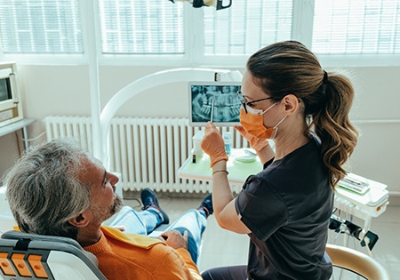 Happy dental patient making thumbs-up gesture