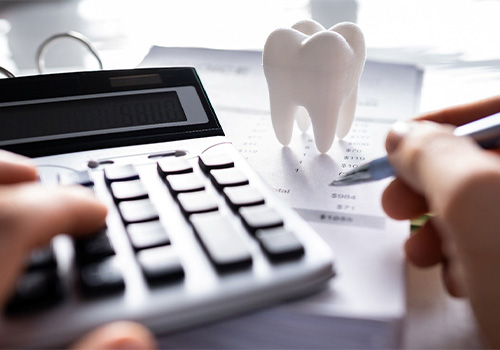 A patient trying to calculate the cost of their dental implants