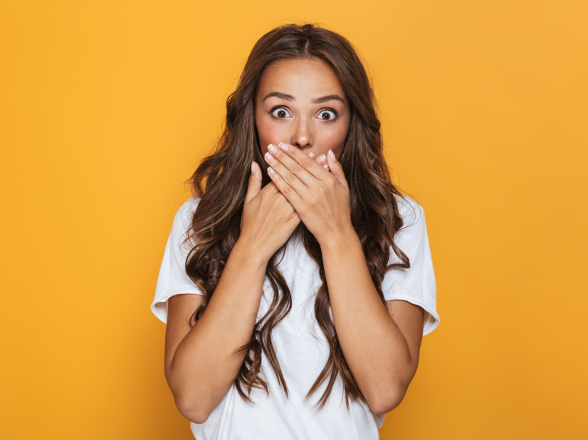 Woman covering mouth, embarrassed