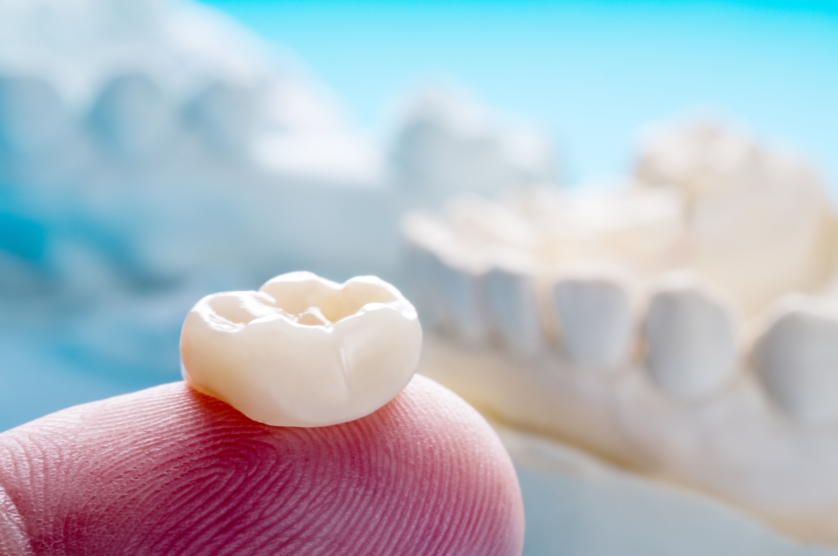 Dental crown on a fingertip